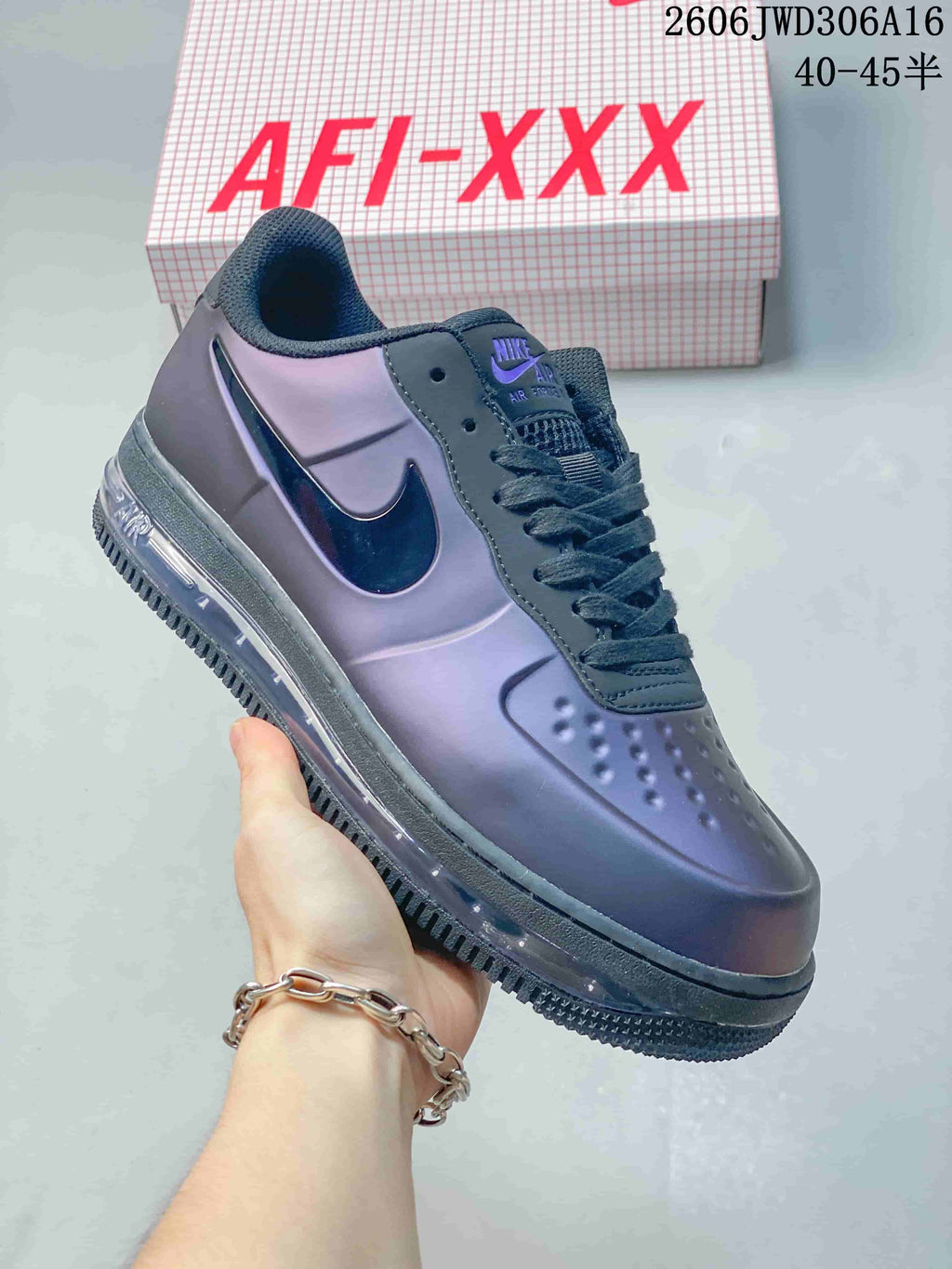 Angled side view of the purple low-top sneaker with dark laces and Swoosh detail