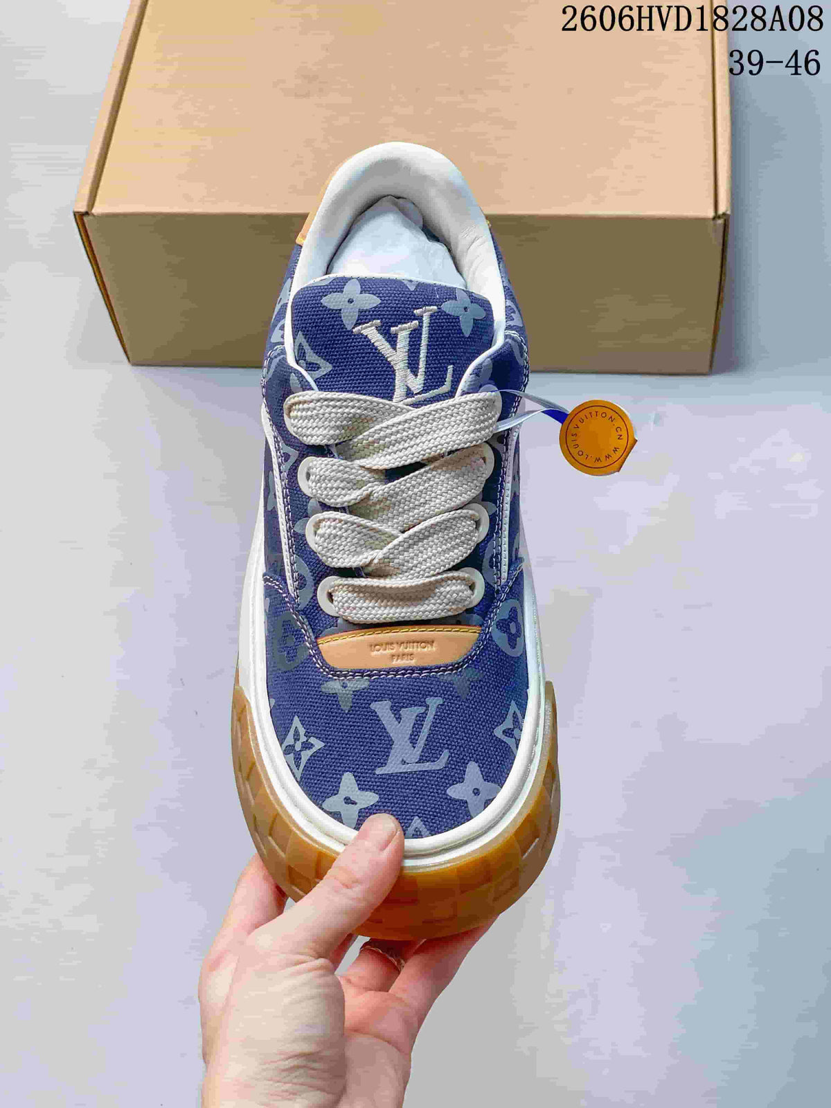 Top view of the sneaker showing white laces and an all-over blue pattern