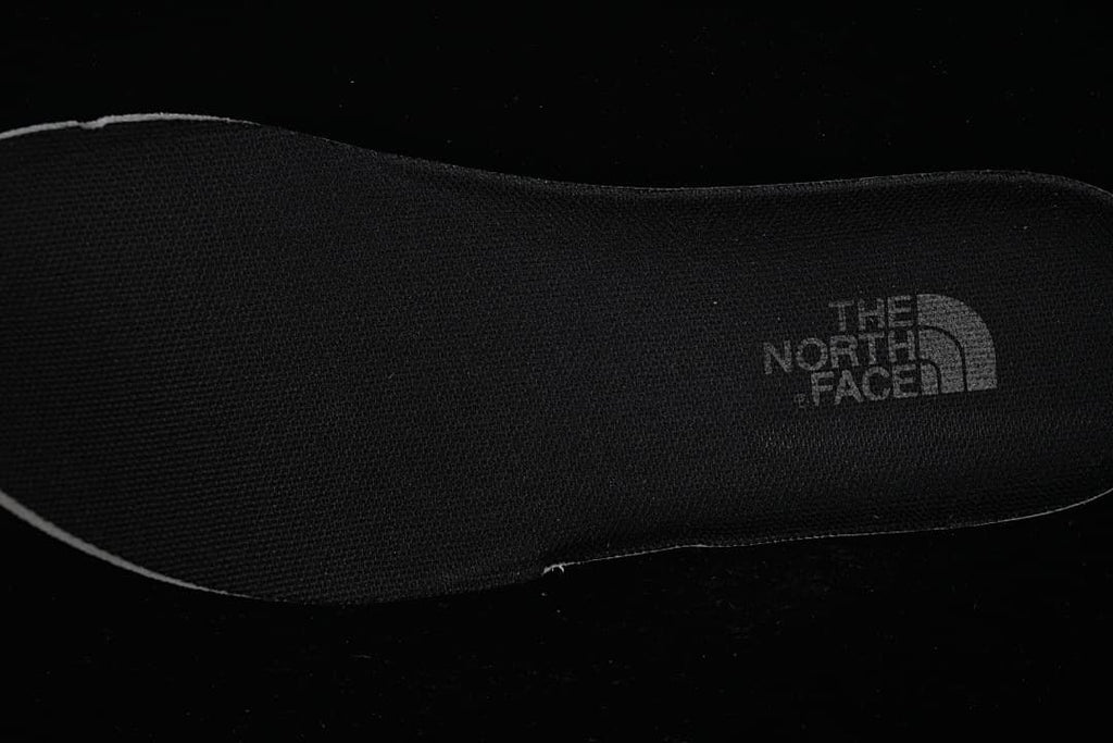 Close-up of a black shoe insole with The North Face branding.