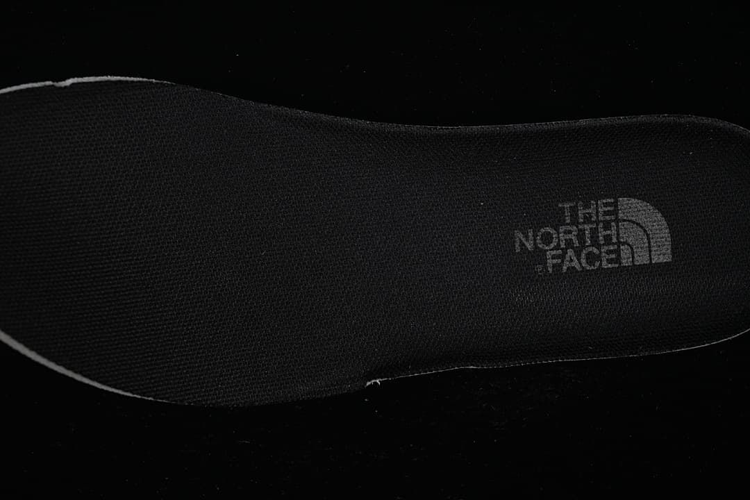Close-up of a black shoe insole with The North Face branding.