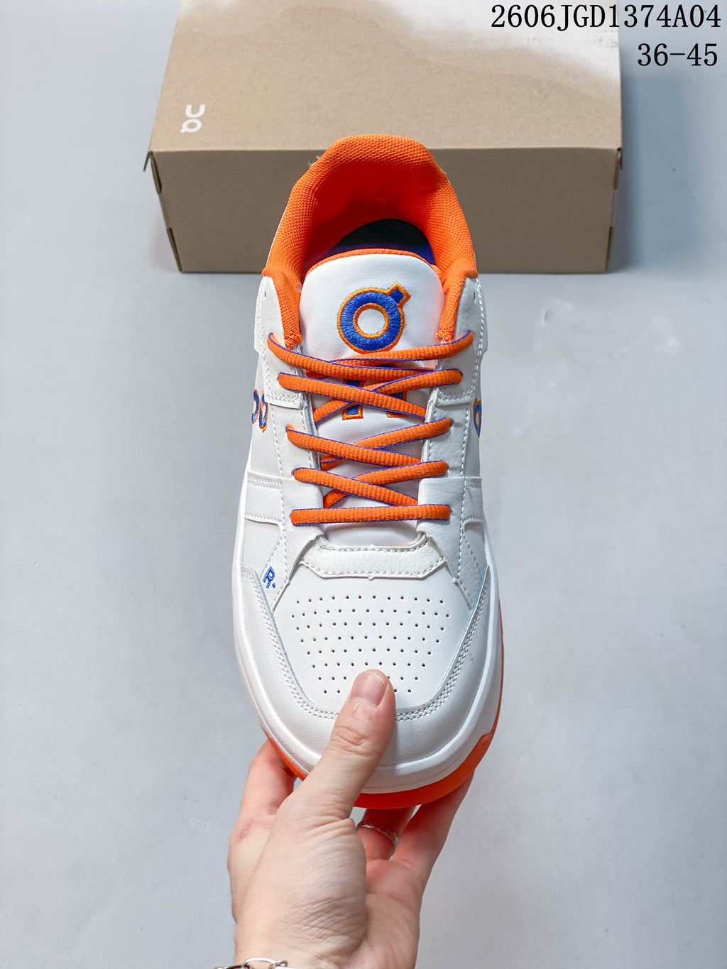 Top view showing the perforated toe, orange laces, and orange collar lining