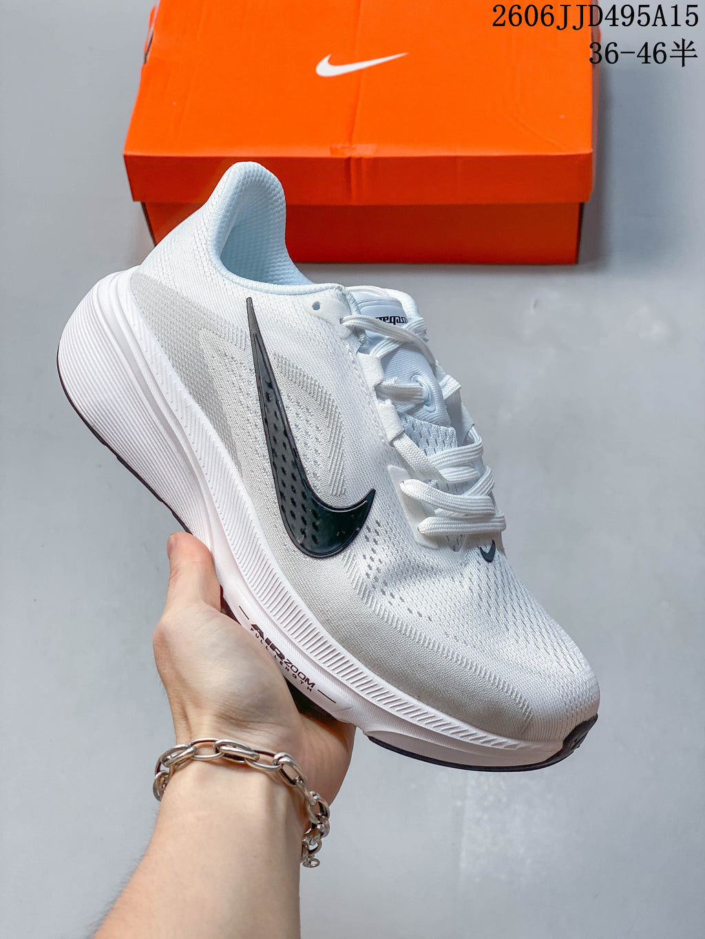 Side view of a white Nike running shoe with a dark Swoosh