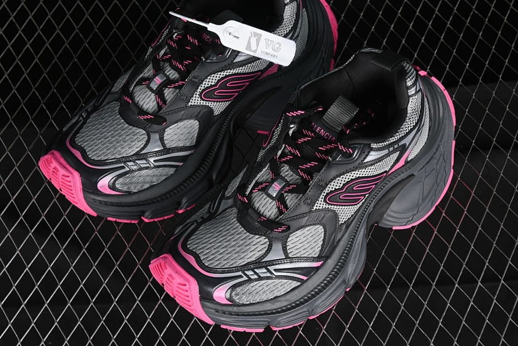 Pair of grey and black chunky sneakers with bright pink details