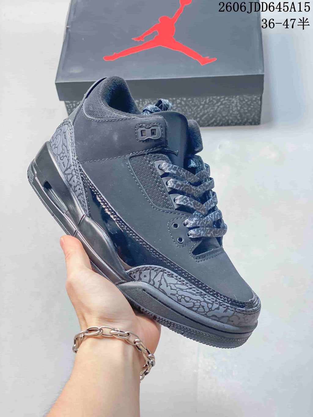 Dark gray low-top Jordan sneaker with patterned overlays and matching laces.