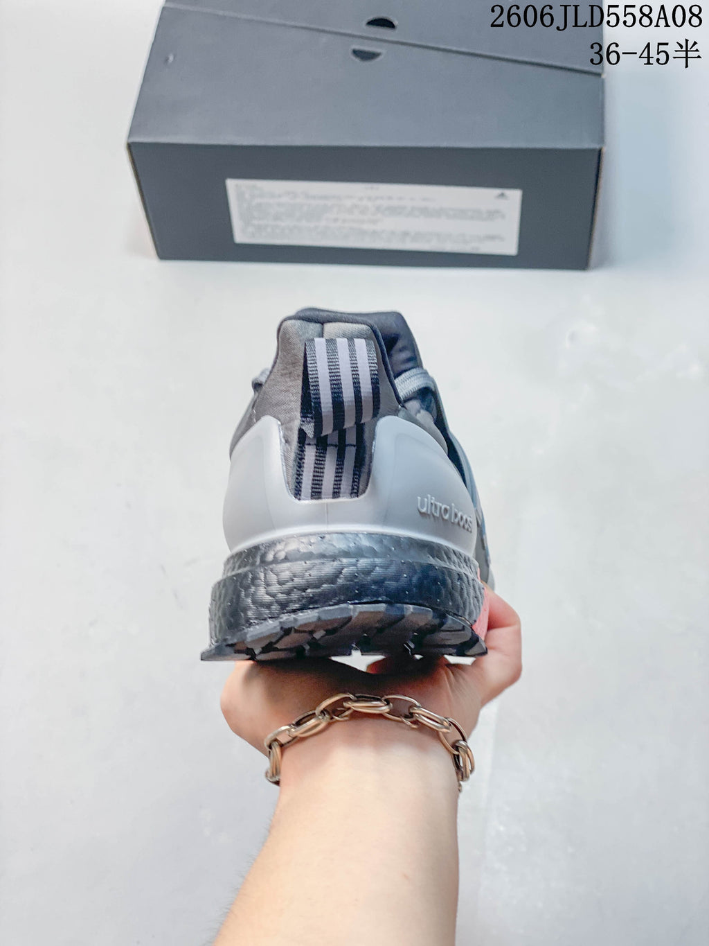 Rear view showing the grey heel counter, striped pull tab and cushioned-looking midsole.