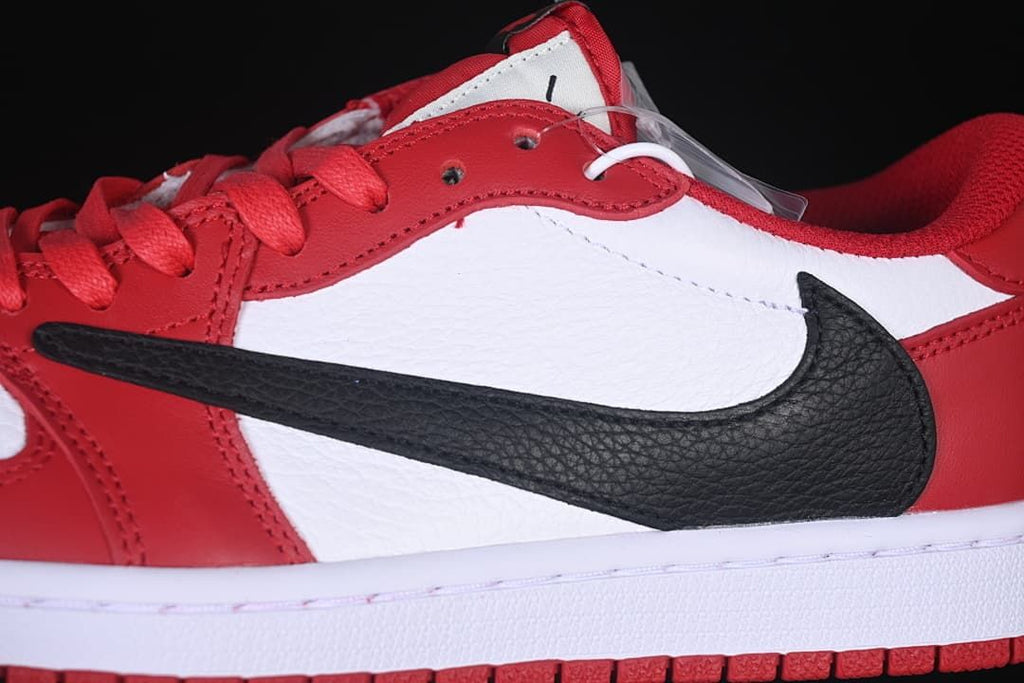 Close-up of the black side Swoosh over white and red panels.