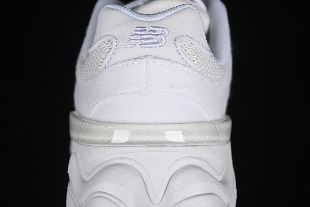 Close-up of the heel, logo, and sculpted sole.
