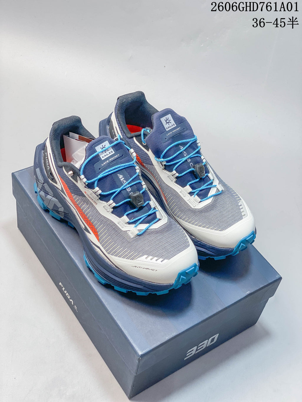 Pair of gray, navy, white, and orange Kailas FUGA EX330 II trail running shoes with blue quick laces.