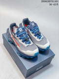 Pair of gray, navy, white, and orange Kailas FUGA EX330 II trail running shoes with blue quick laces.