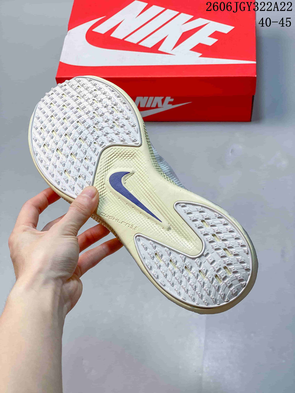 Close-up of the patterned outsole on a white Nike Ava X shoe.