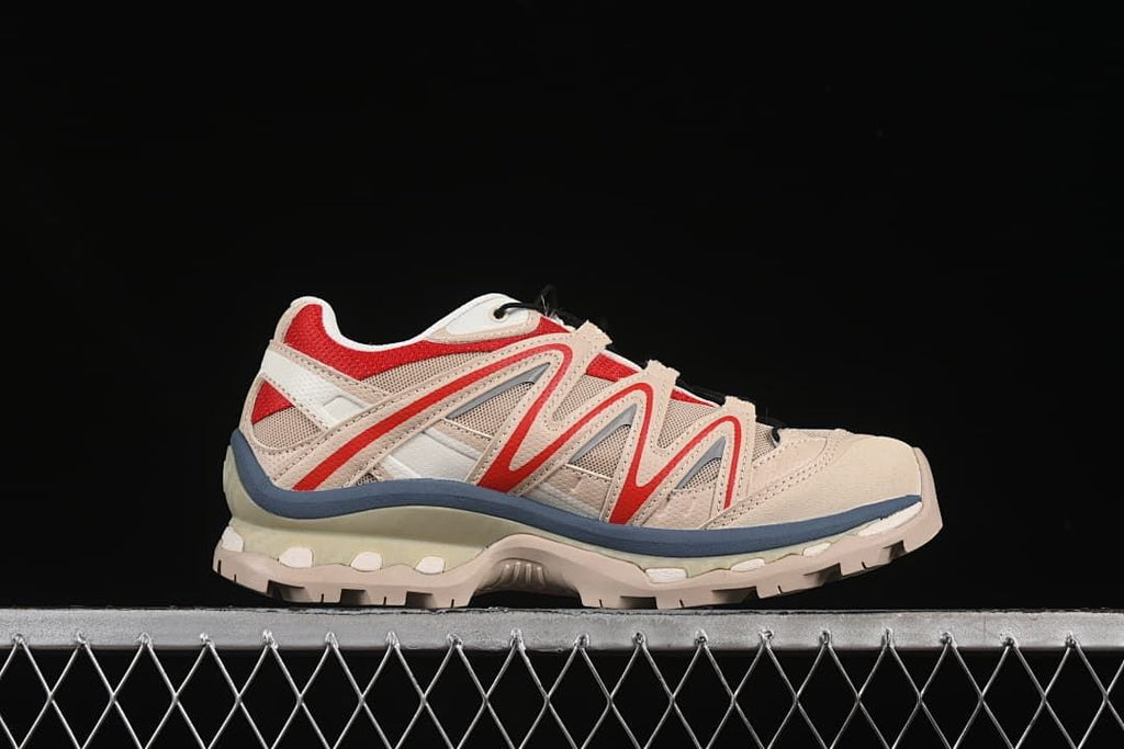 Side profile highlighting the red overlays and layered sole
