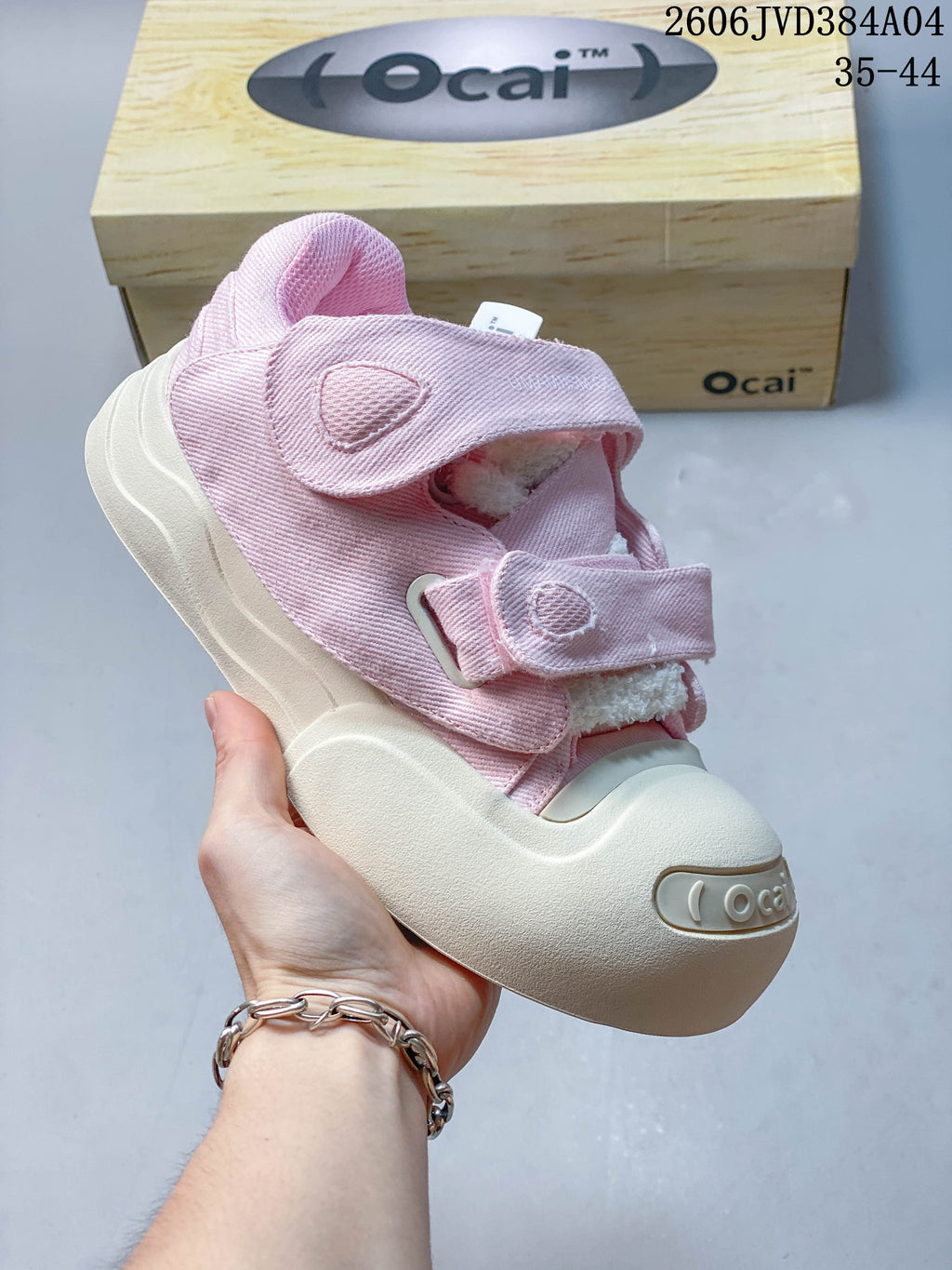 Close-up of a pink Ocai sneaker with hook-and-loop straps