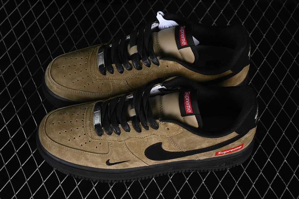 Pair of khaki and black low-top sneakers viewed from above