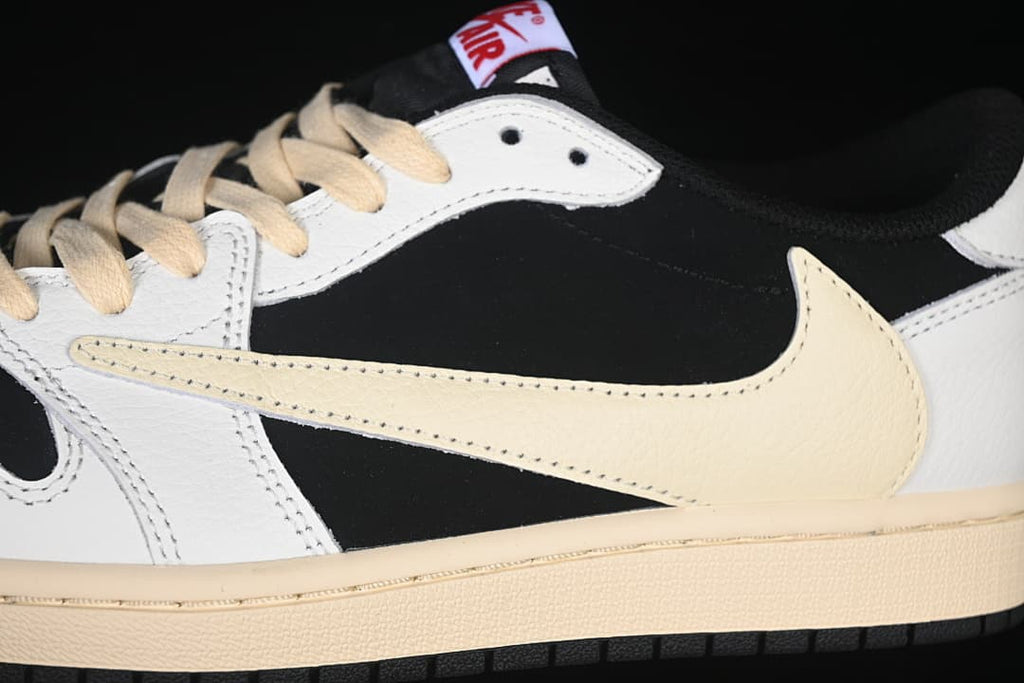Detail of the cream-colored Swoosh, black side panel, and white overlays.