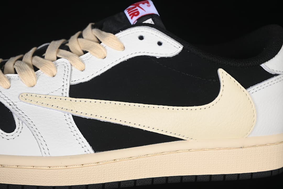 Detail of the cream-colored Swoosh, black side panel, and white overlays.
