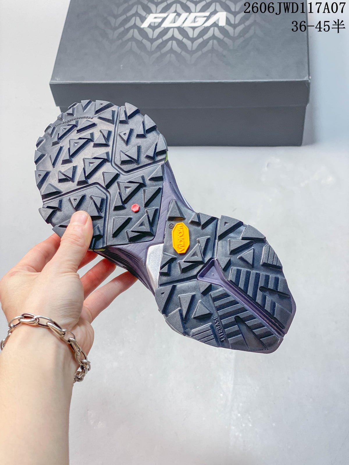 Close-up of the trail shoe outsole showing prominent angular lugs and a Vibram mark.