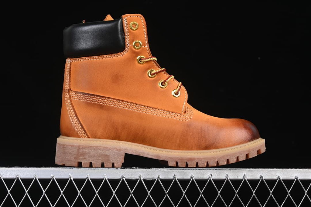 Side profile of the wheat-colored boot with padded collar and lugged sole