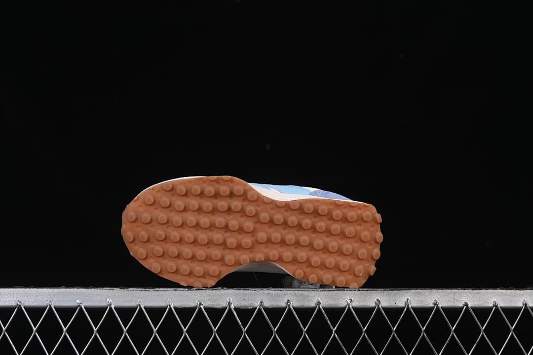 Underside view of the gum-colored outsole with a round-lug tread pattern.