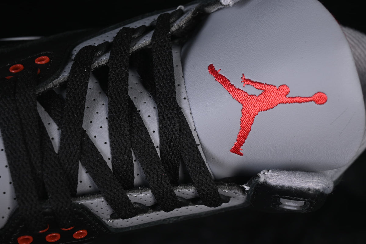 Close-up of black laces, red eyelets and the red tongue logo