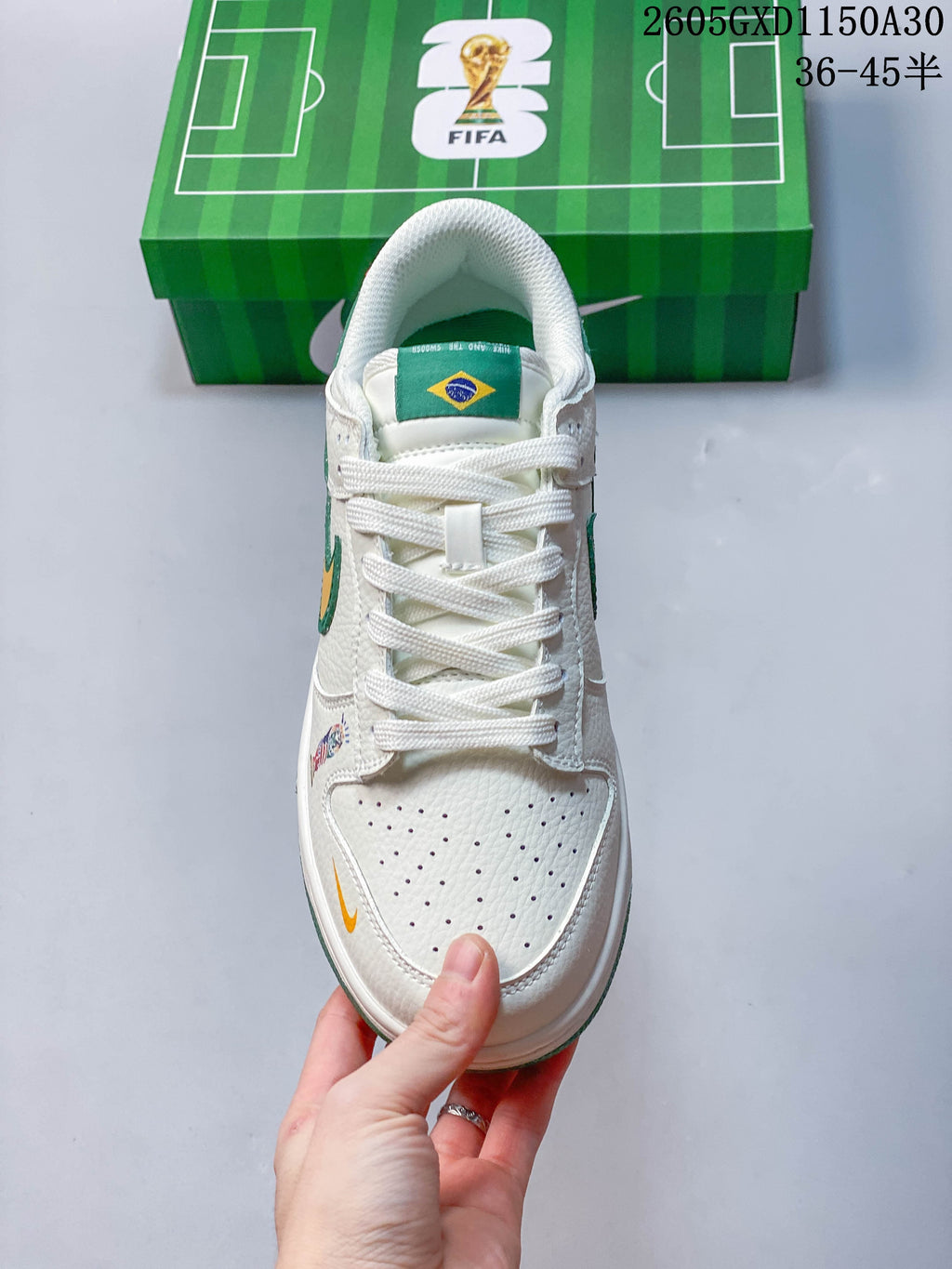 Front view showing the perforated toe, white laces, and green tongue label with a Brazil flag.