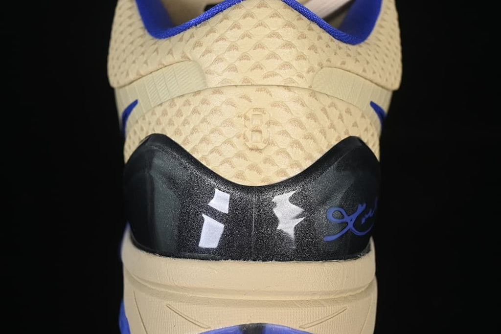 Rear view showing the heel details and cream patterned upper.