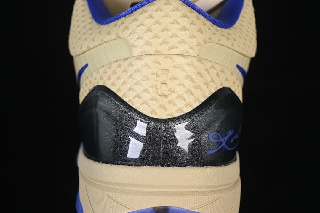 Rear view showing the heel details and cream patterned upper.