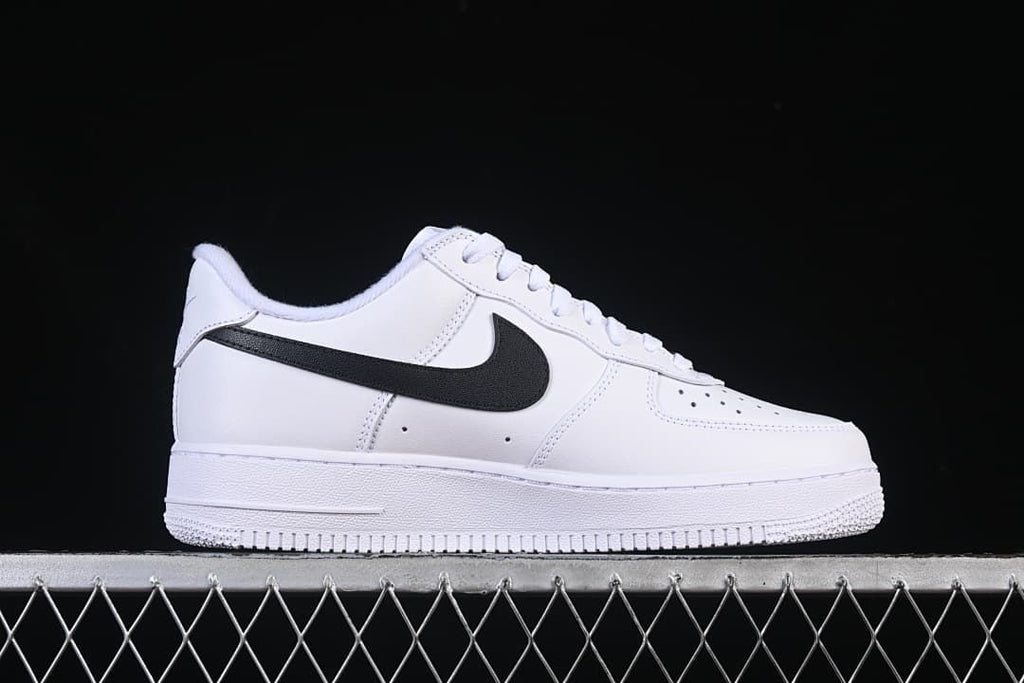 Outer side view of white sneaker with black Swoosh
