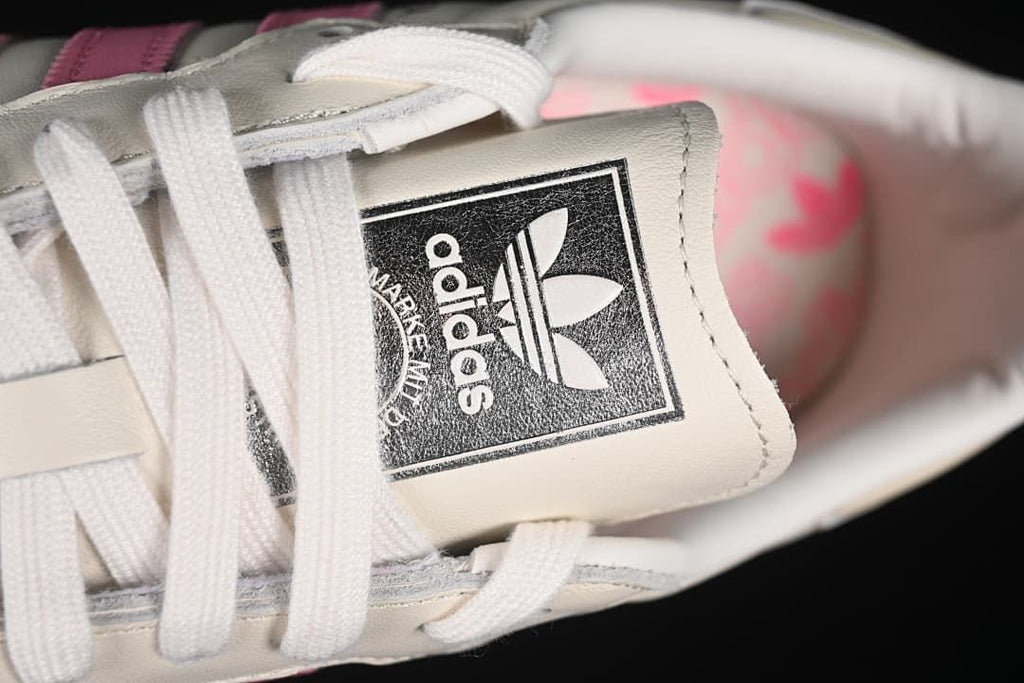 Close-up of the adidas tongue label and white laces