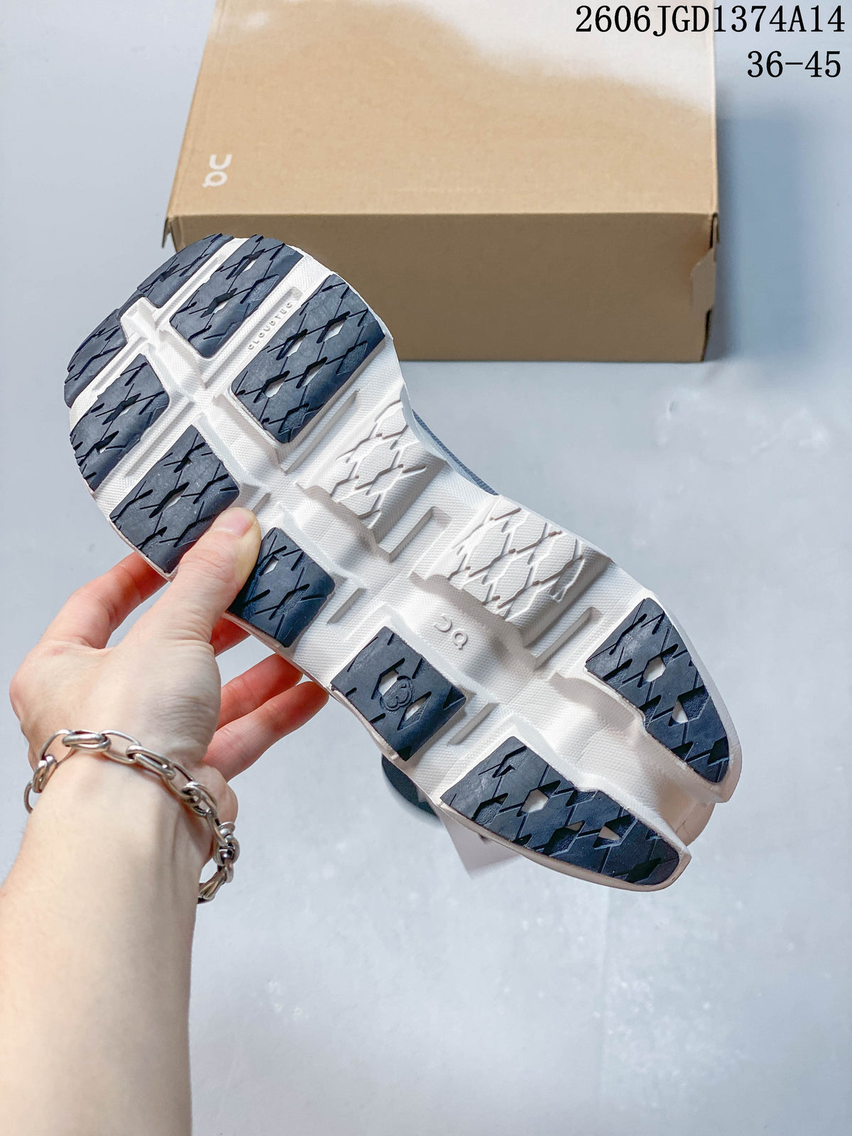 Underside of the shoe showing dark rubber tread patches and a white outsole.