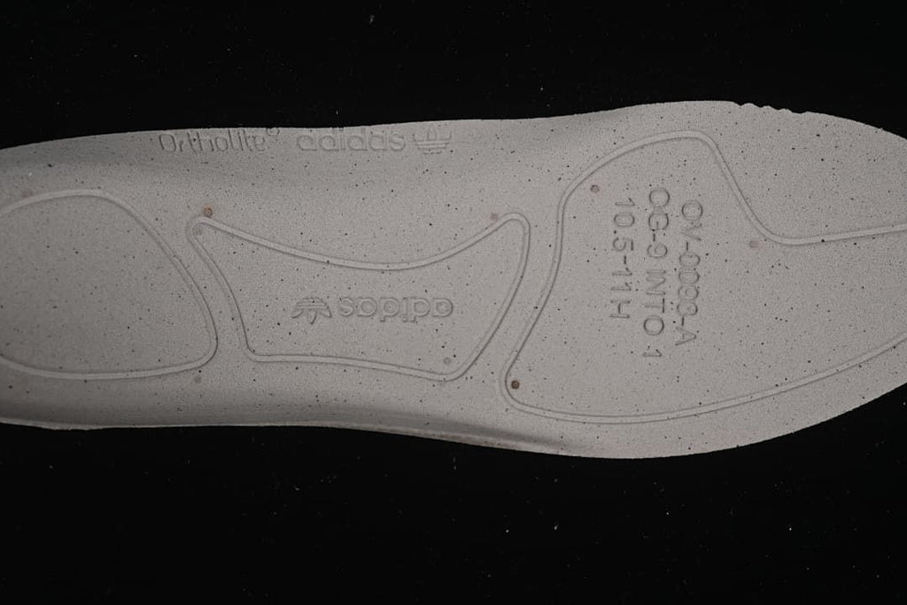 Close-up of the outsole with molded branding and markings
