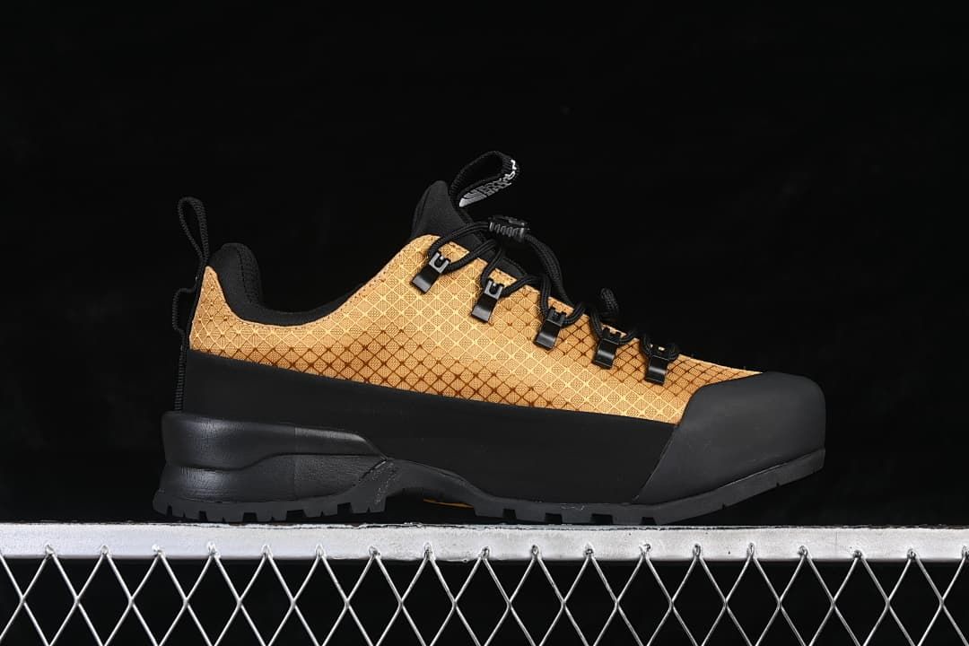 Side profile showing the gold patterned upper and black sole
