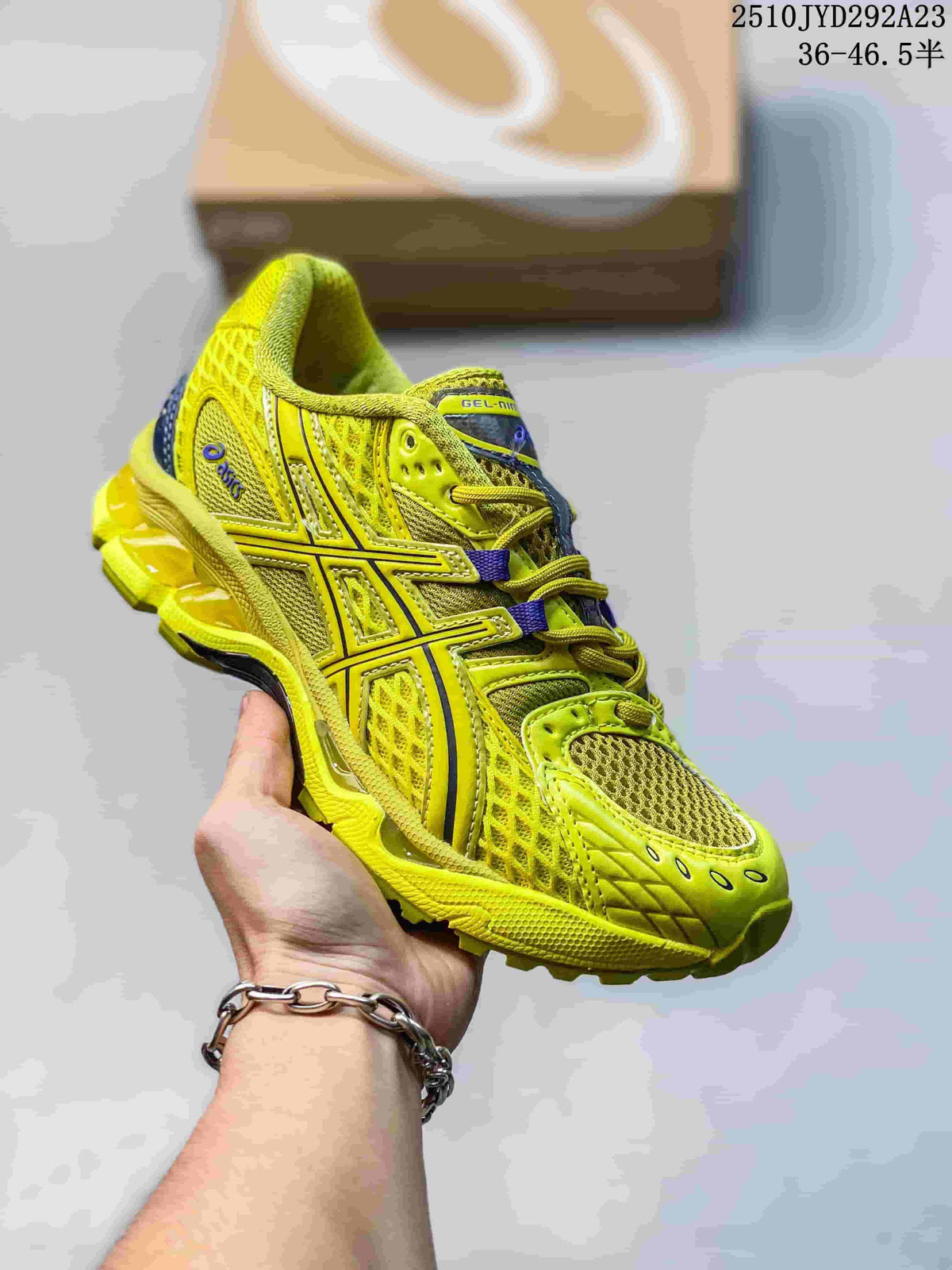 Bright yellow ASICS Gel-Kayano 14 sneaker with mesh panels and purple accents