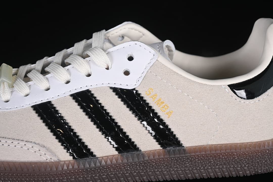Close-up of beige upper, black side stripes, and brown outsole