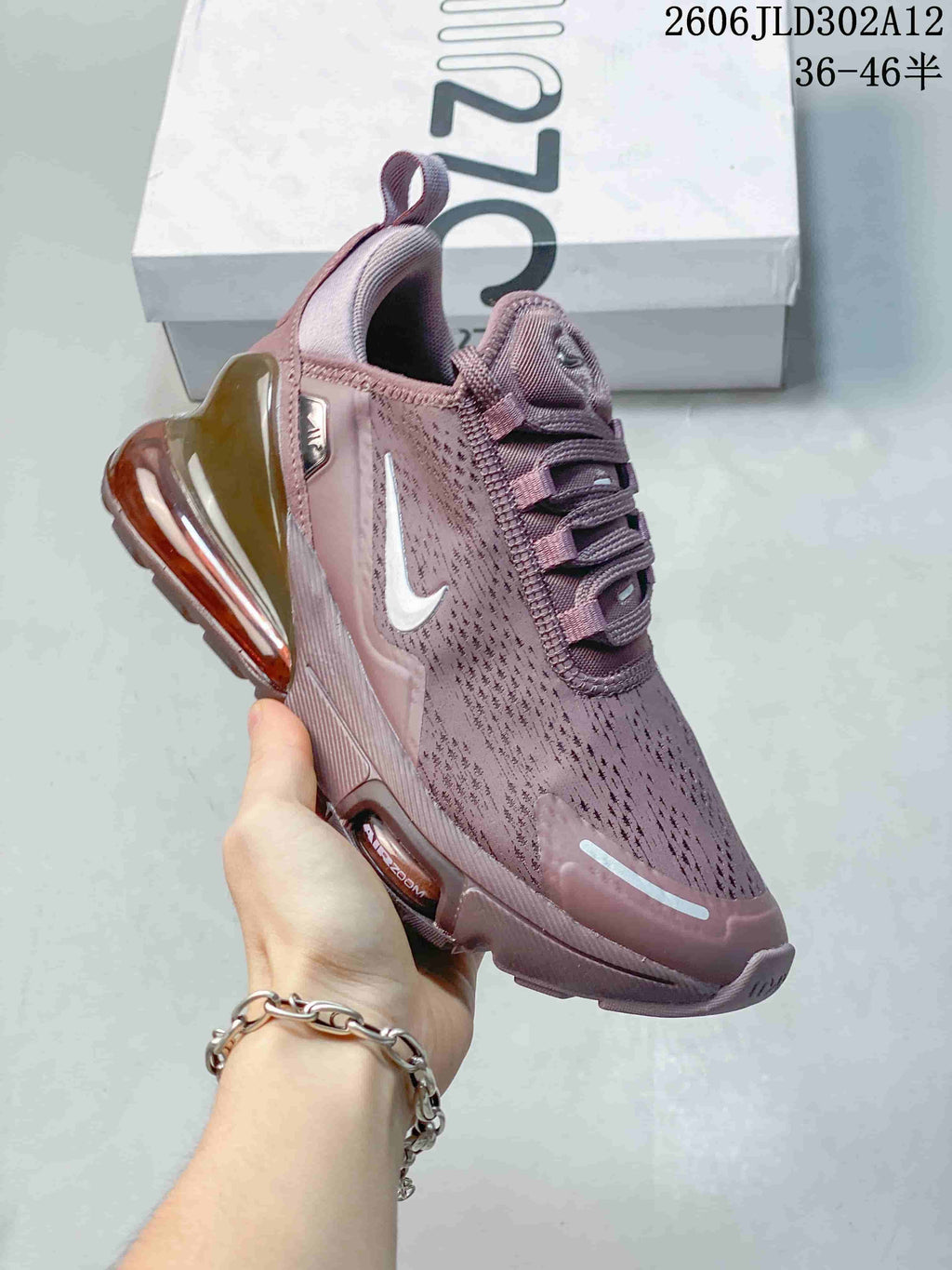 Angled front and side view of a mauve Nike Air Max 270 sneaker