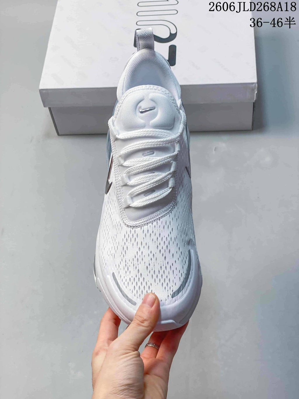 Top view of a white Nike Air Max Pulse shoe showing its laces and patterned upper