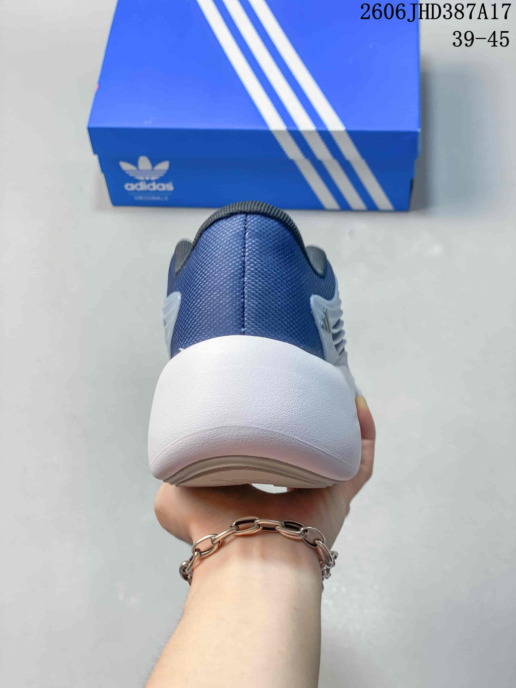Rear view of the sneaker with a blue heel and thick white sole