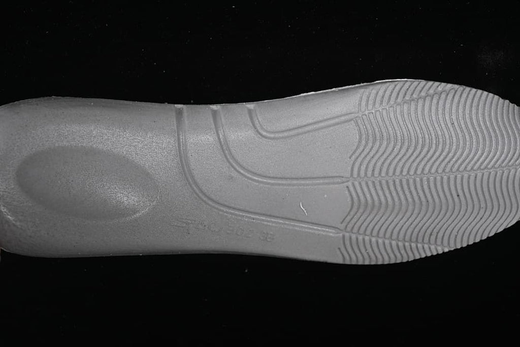 Underside view of the sneaker outsole with molded tread.