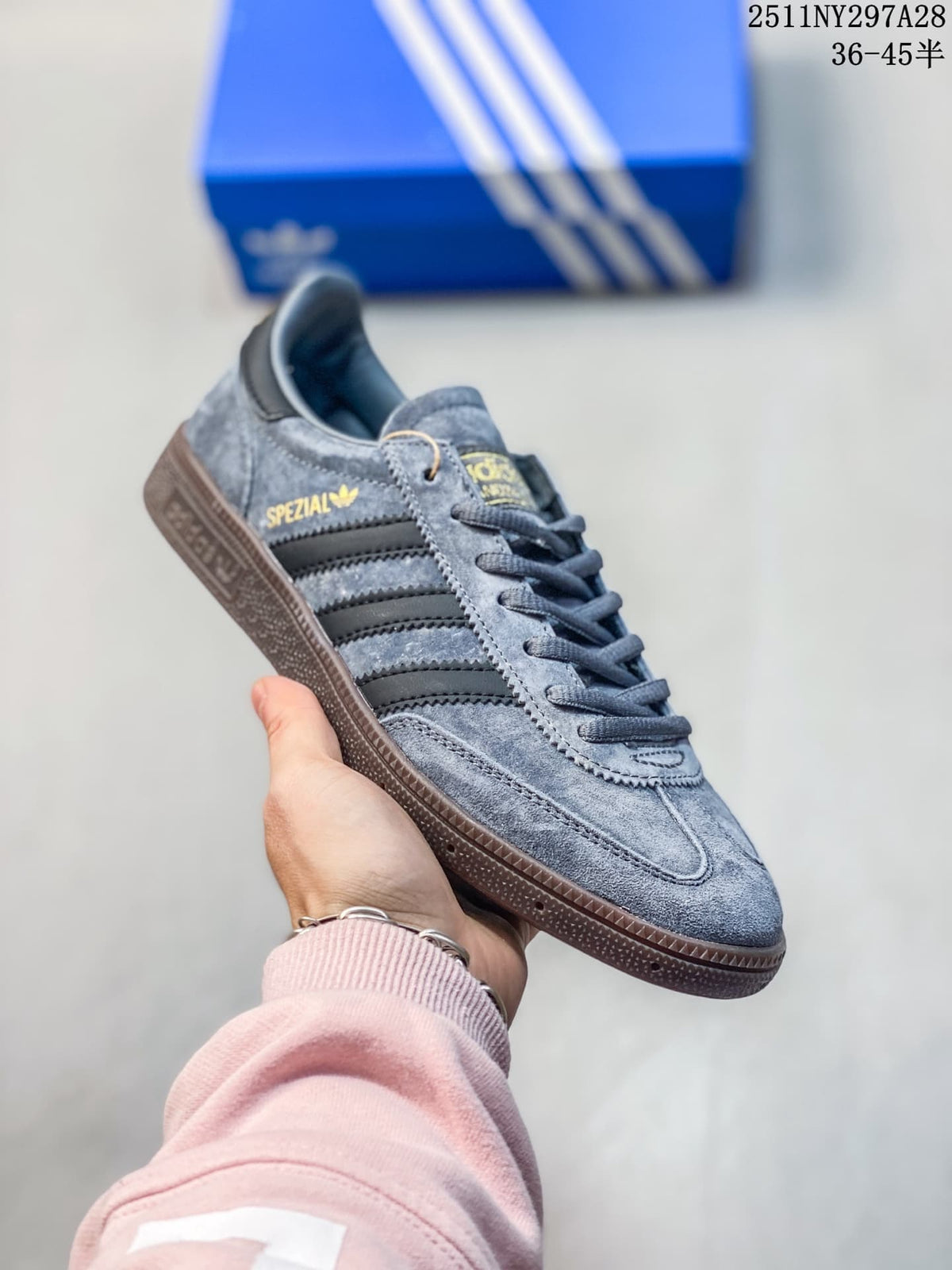 Angled side view highlighting the gray upper, black stripes, and brown outsole