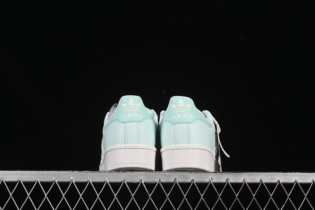 Rear view of the pair showing mint heel tabs and white soles
