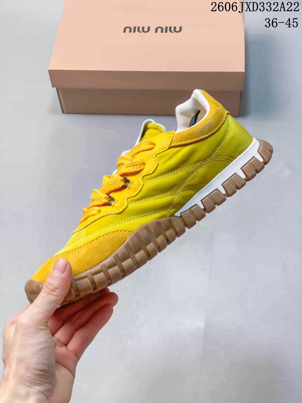 Side view of the yellow low-top sneaker with suede-look overlays