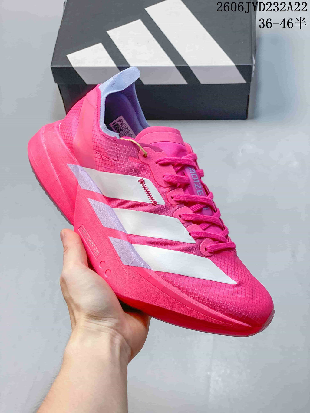 Side view of a pink running shoe with white stripes and a sculpted sole.