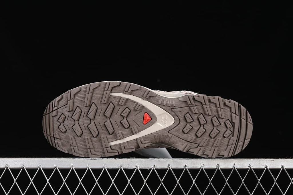 Underside view showing the lugged outsole and red accent