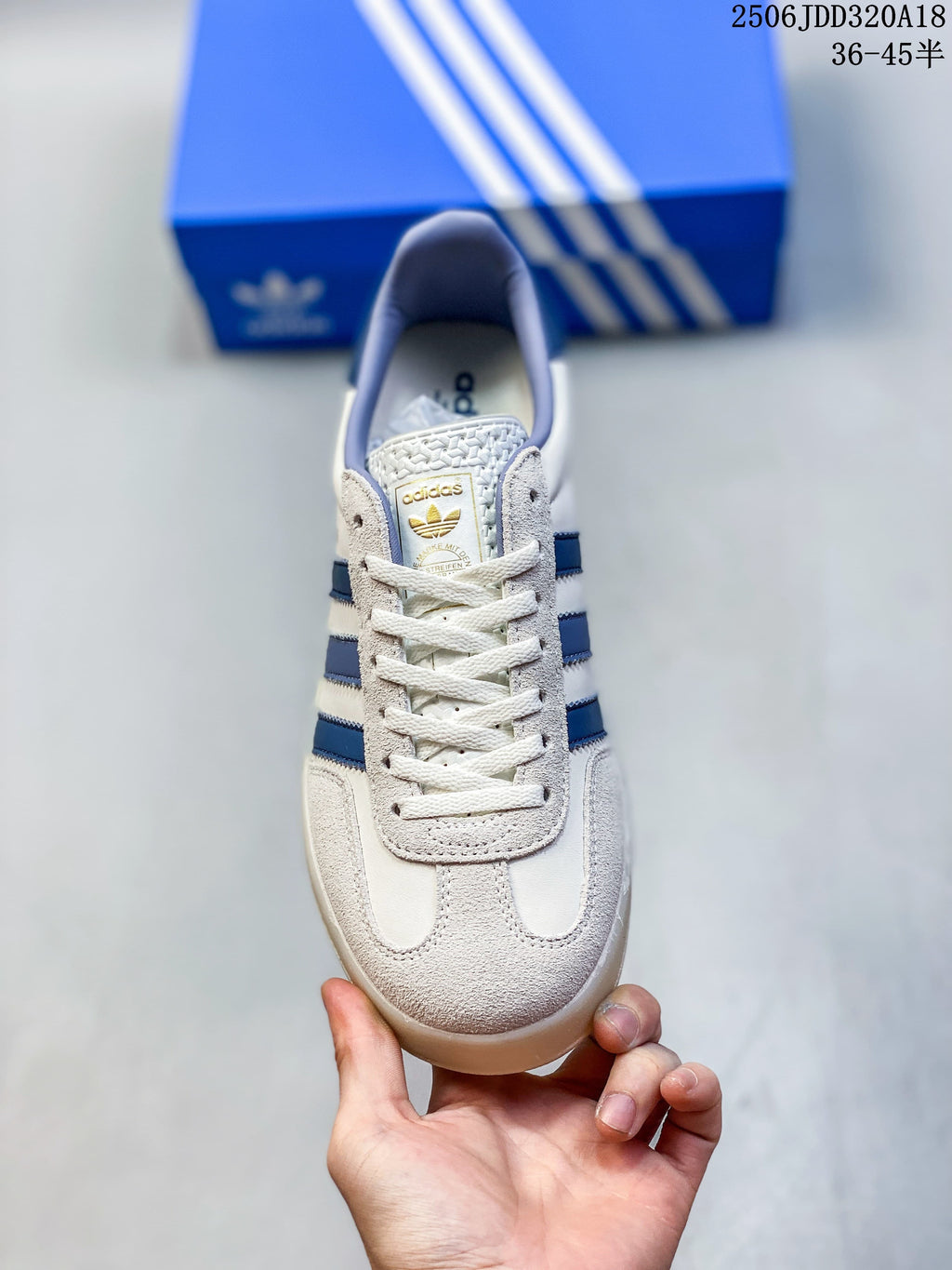 Front view of the lace-up sneaker with a suede-look toe panel and blue side stripes.