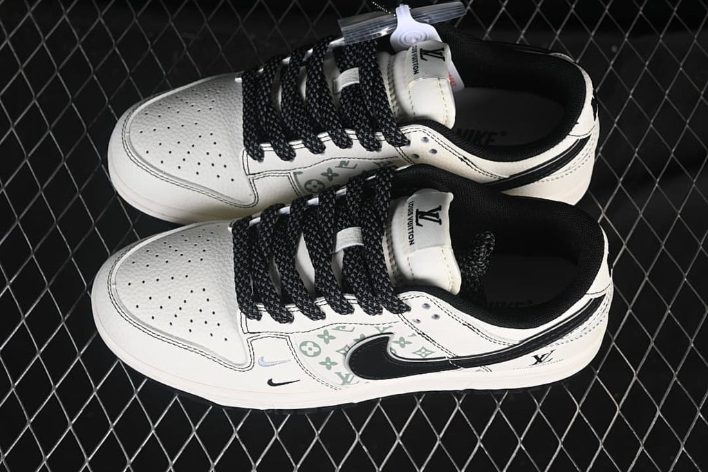 Overhead view of a pair of cream and black low-top sneakers with patterned side panels and black laces.