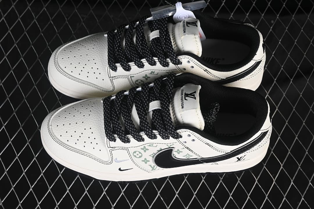 Overhead view of a pair of cream and black low-top sneakers with patterned side panels and black laces.