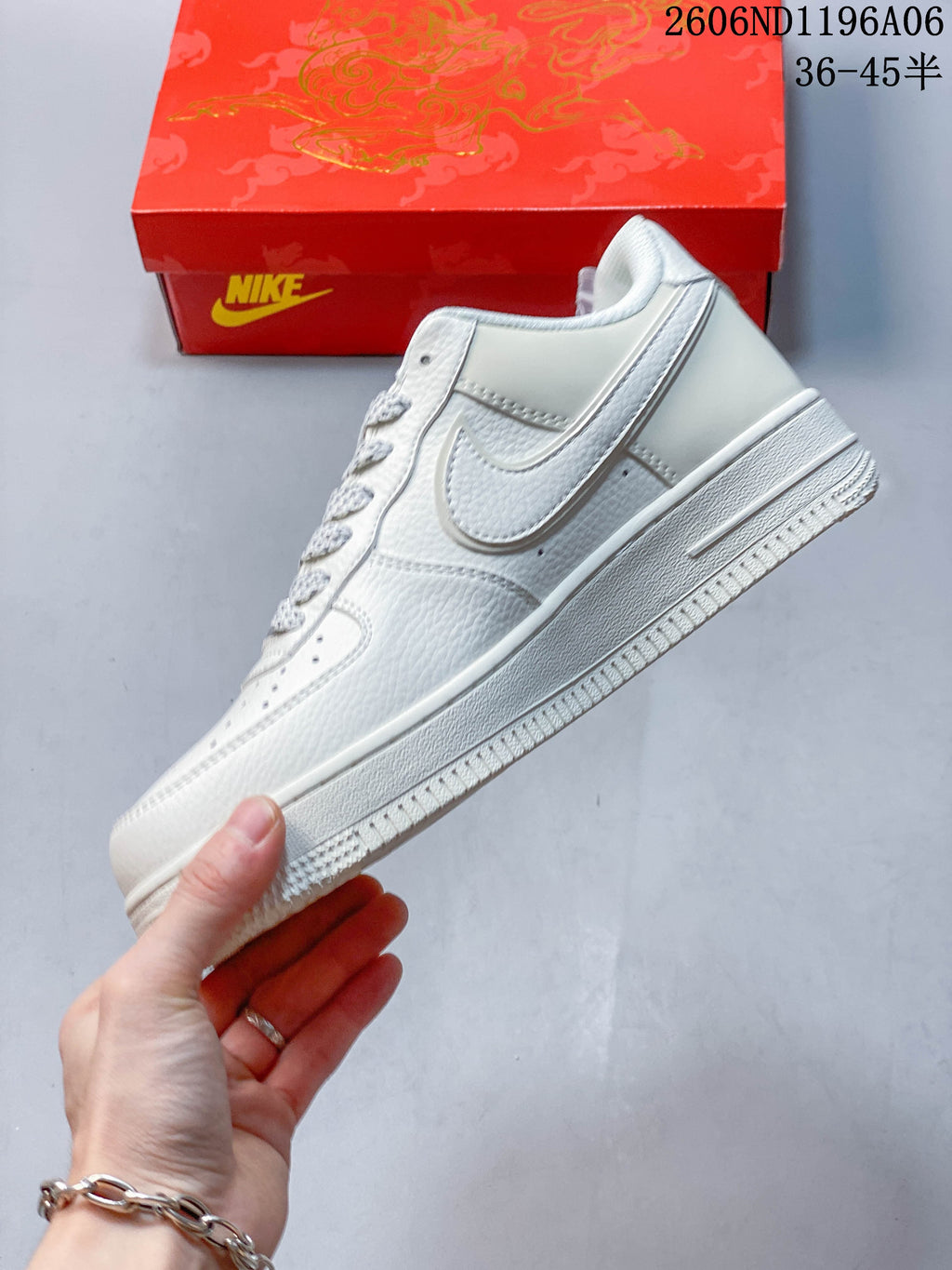 Side profile of the white low-top sneaker with layered panels