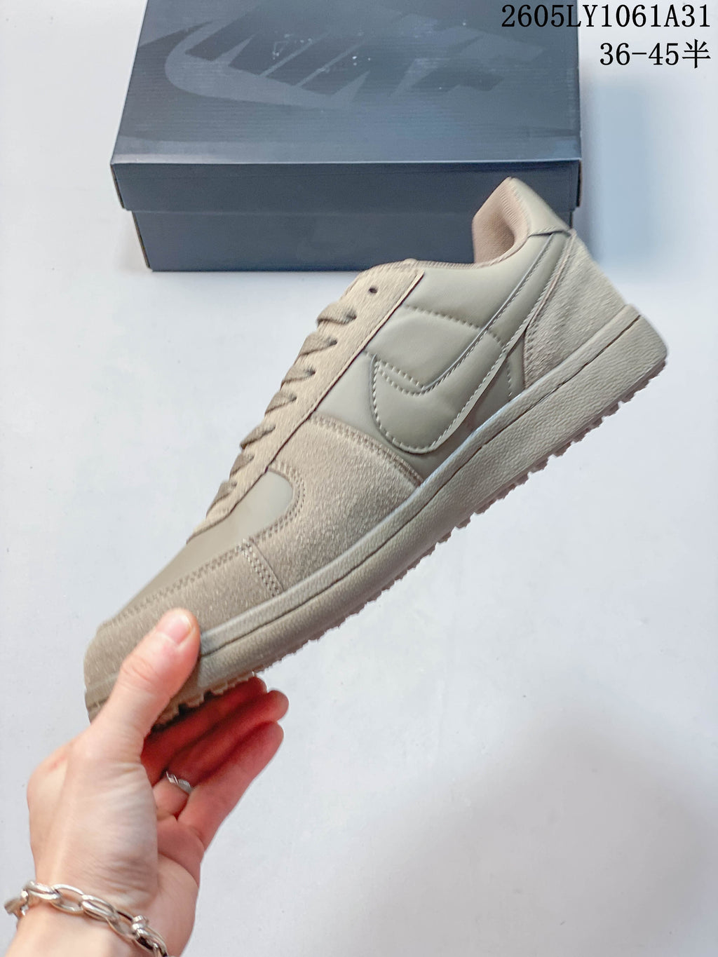 Side profile showing the Swoosh and contrasting textured panels
