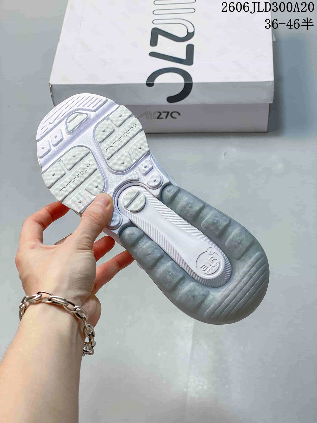 Outsole view showing the patterned tread and heel unit of a white Air Max 270 sneaker