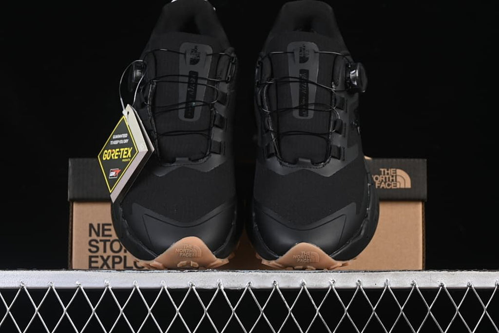 Front view of the pair displayed with the shoe box and a GORE-TEX hangtag.