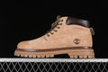 Side profile of a beige Timberland ankle boot with brown collar and lugged sole